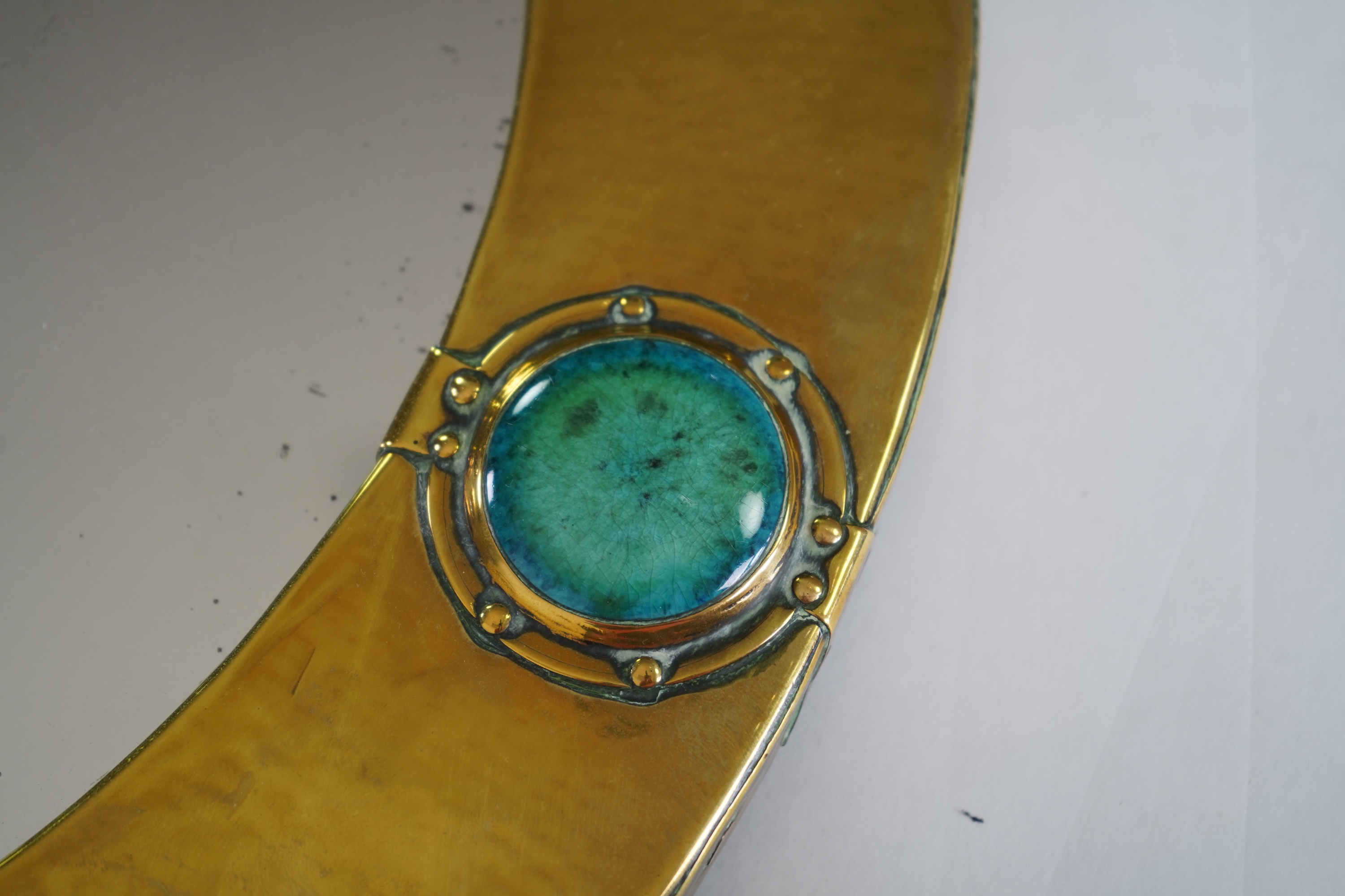 Liberty & Co.: An Arts And Crafts brass and Ruskin pottery cabochon mounted mirror